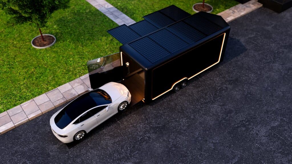 A white car goes into a black garage trailer on the street