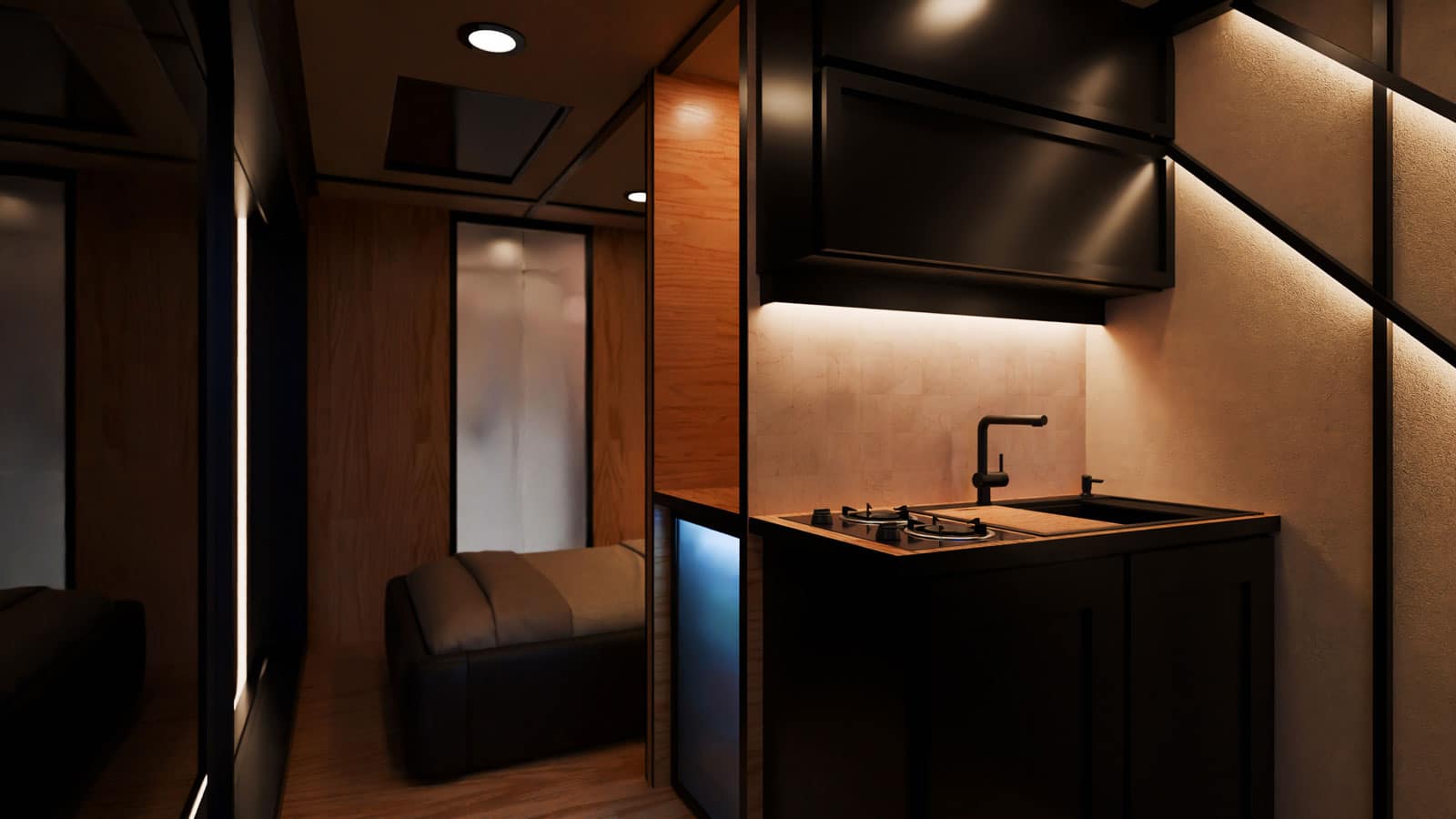 The camping trailer has a mini fridge, kitchen, and bed on the interior